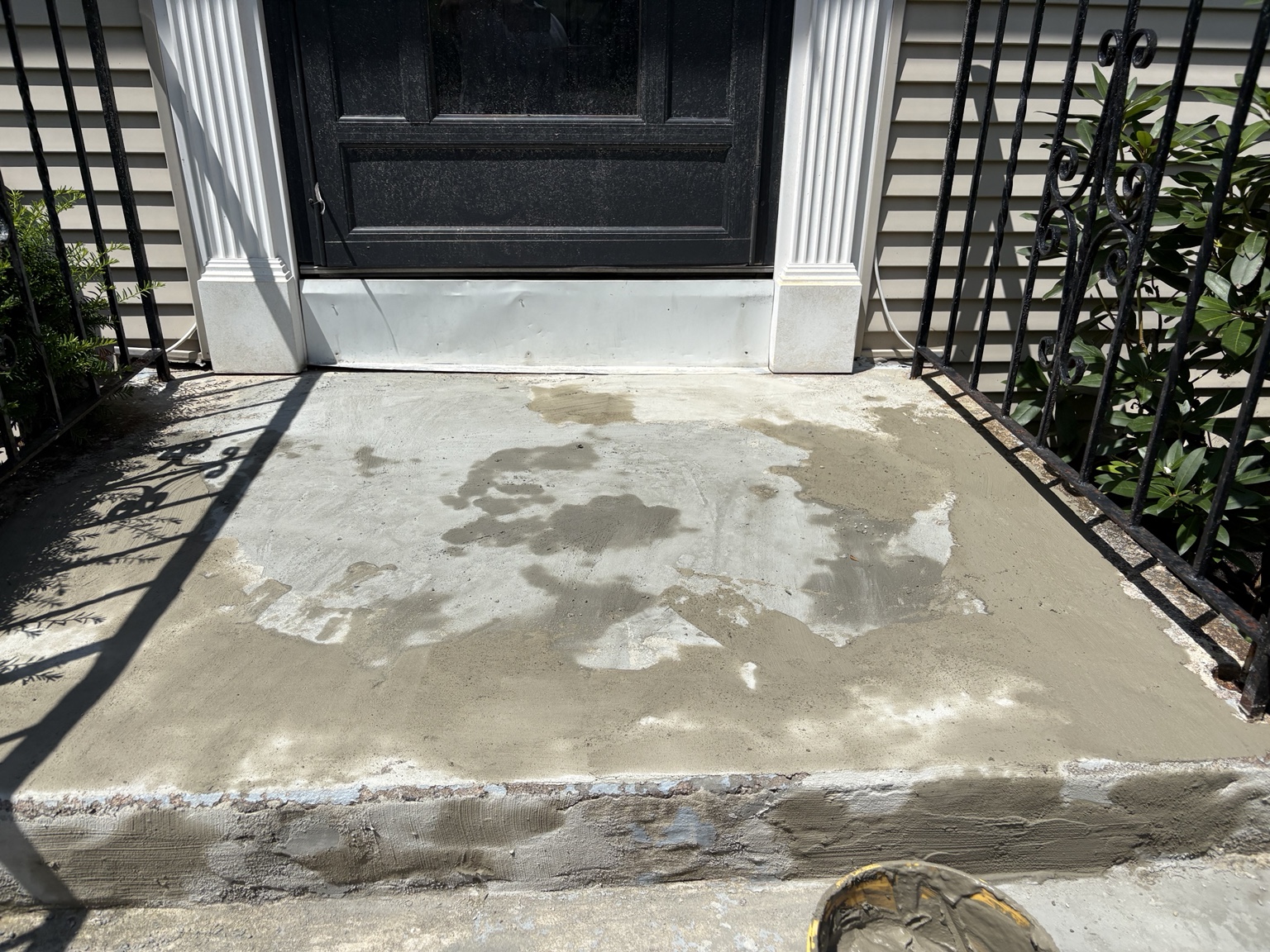 Concrete front entry landing during surface repair
