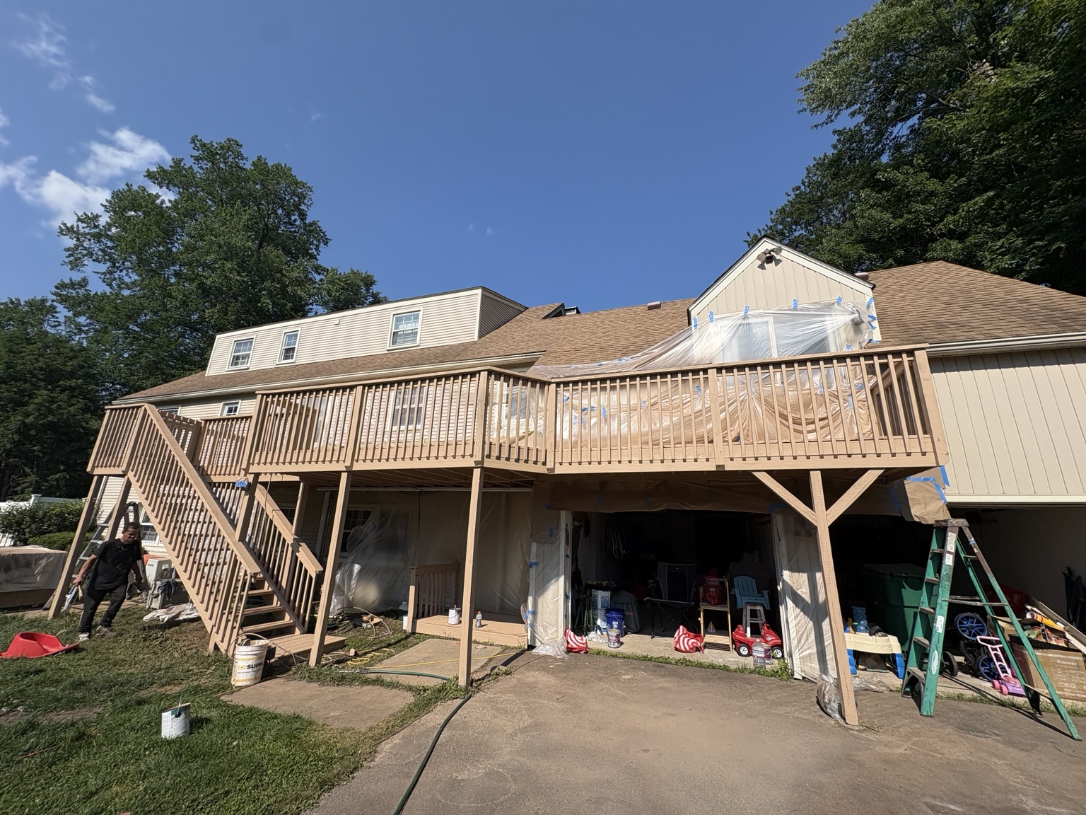 Large rebuilt raised deck with wooden stairs and railings